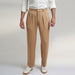 a medium size model wearing beige color trouser made from organic lotus silk fabric. the pant is a basic straight fit with 2 pleats and turn up bottom.