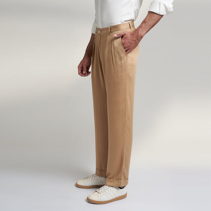 a medium size model wearing beige color trouser made from organic lotus silk fabric. the pant is a basic straight fit with 2 pleats and turn up bottom.