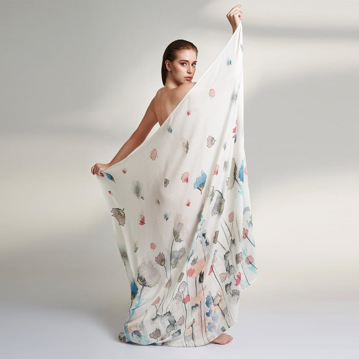 A Square organic Aloe vera fabric scarf, printed on a white base with multicolor flowers and petals flying.