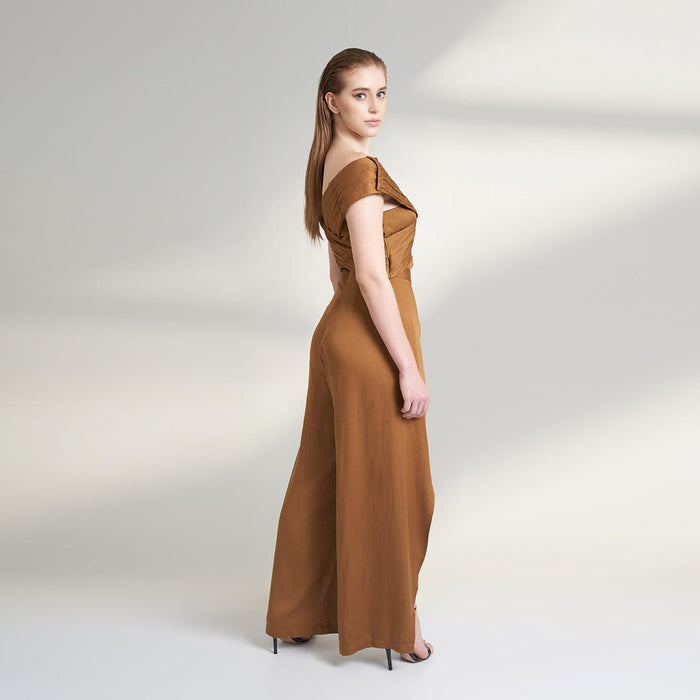 A brown tan color jumpsuit with wrap around ruched front bodice with overlap front slit pants.