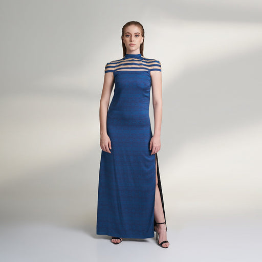 A printed blue long evening dress crafted in organic lotus silk and organza fabric accentuated with a thigh high slit and a short stripe cape attached to the dress.