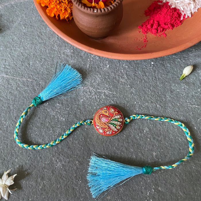 Tanjore Rakhi - Orange stone & Blue thread