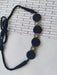 Black choker necklace with round charms in silver and black on white backdrop