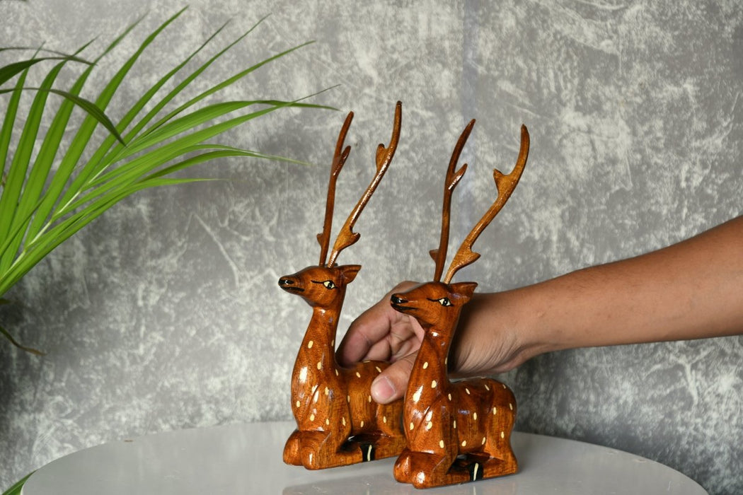 Pair of wooden sitting deer